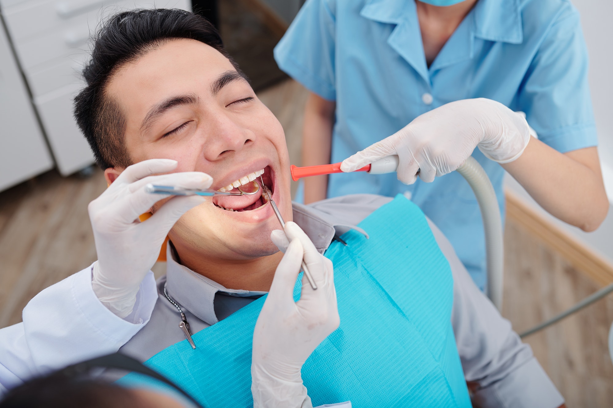 Dentist treating teeth of patient